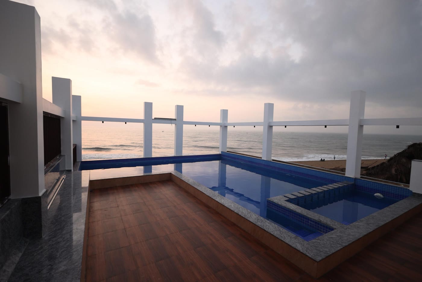 Evening view of the rooftop pool and beach at Samudra Beach Resorts, Kovalam